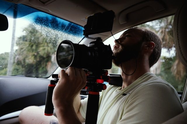 a man holding a film camera